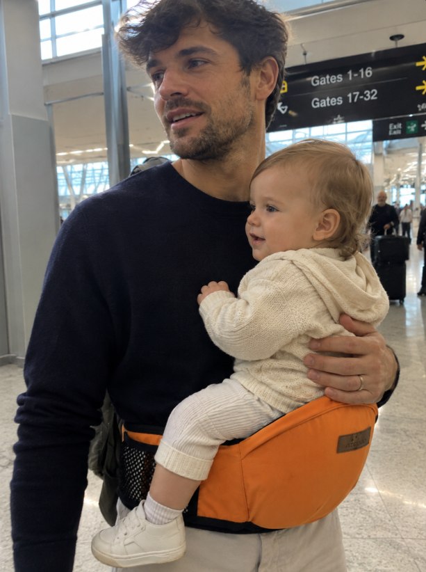 Diane R. carrying her grandchild